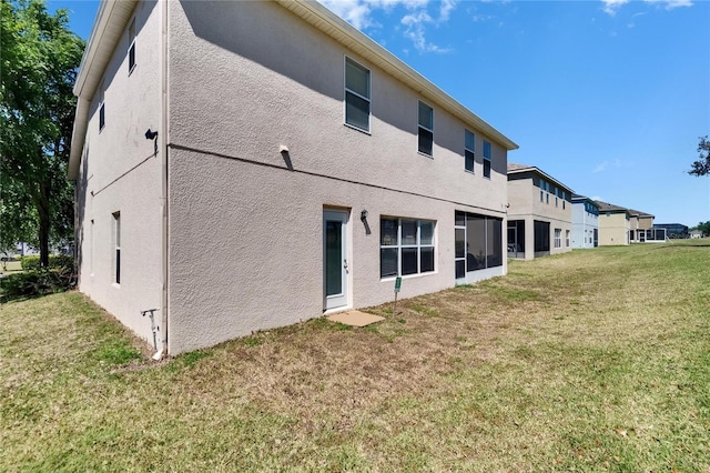 13421 Sydney Rd, Valrico, FL 33594 - rear view of property with a lawn and stucco siding