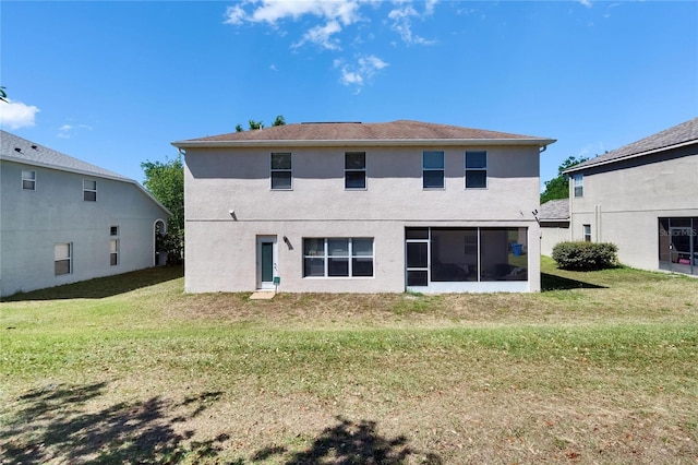 13421 Sydney Rd, Valrico, FL 33594 - rear view of house featuring stucco siding, a sunroom, and a yard