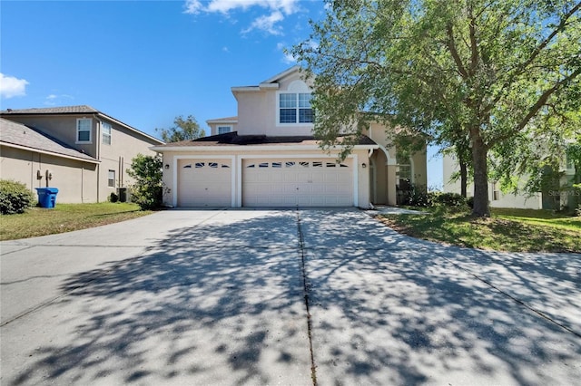 13421 Sydney Rd, Valrico, FL 33594 - view of front facade featuring stucco siding, concrete driveway, and a garage