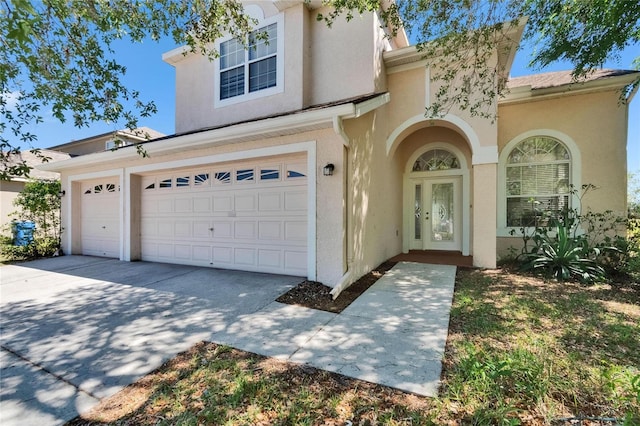 13421 Sydney Rd, Valrico, FL 33594 - view of front of house with stucco siding, concrete driveway, and a garage