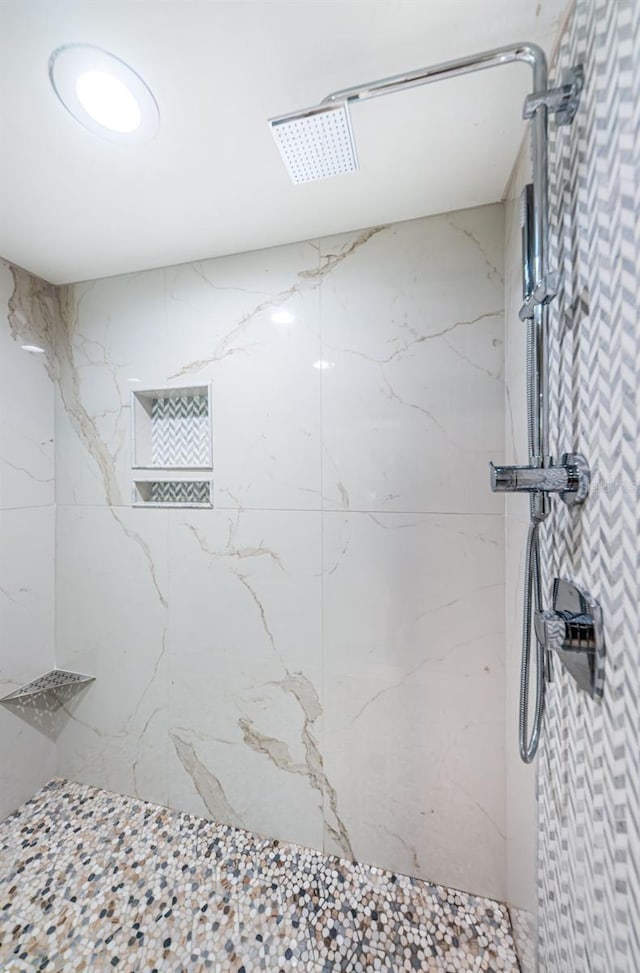 bathroom with a marble finish shower