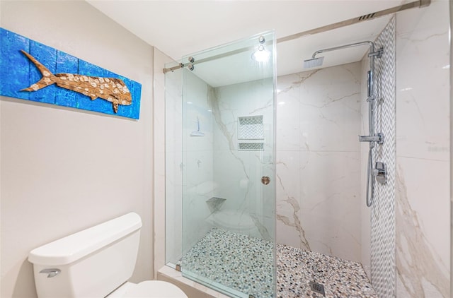 full bathroom with toilet and a marble finish shower