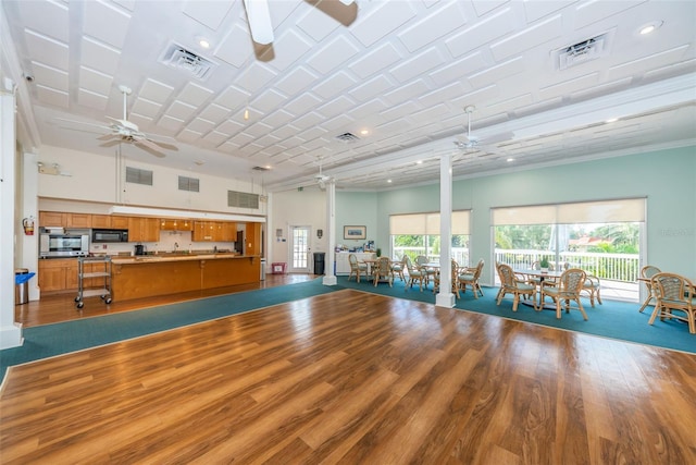 interior space with wood finished floors, visible vents, and ceiling fan