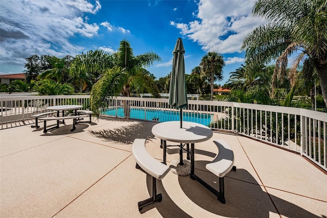 view of patio / terrace with a fenced in pool