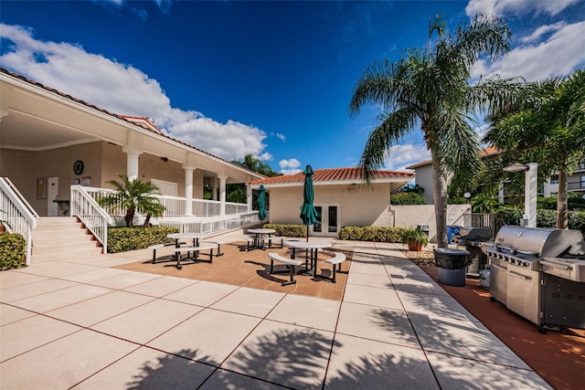 view of patio / terrace with grilling area, stairway, and french doors