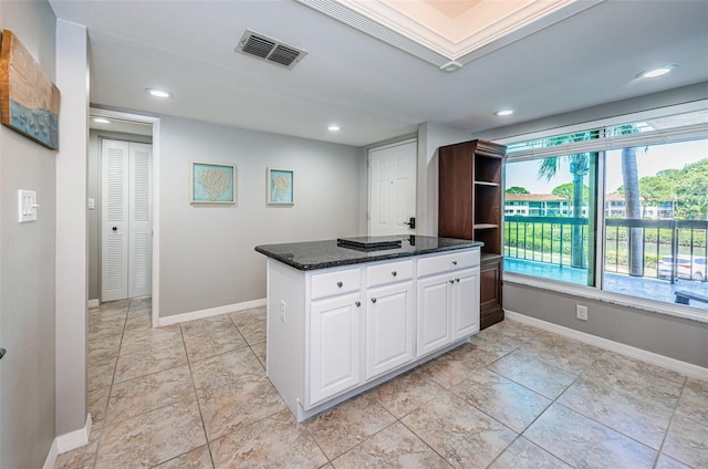 kitchen featuring recessed lighting, dark stone countertops, visible vents, baseboards, and white cabinetry