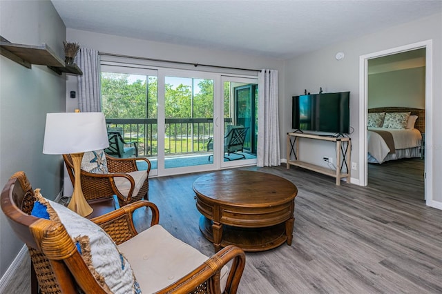 living room with wood finished floors and baseboards