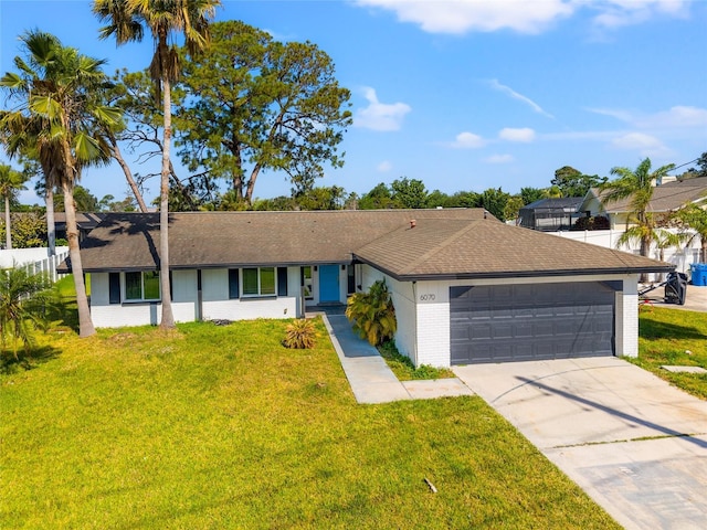 6070 Denver St NE, Saint Petersburg, FL 33703 - ranch-style house with roof with shingles, an attached garage, driveway, brick siding, and a front yard