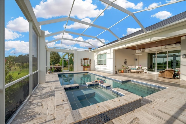 view of swimming pool featuring a patio, a ceiling fan, glass enclosure, and a pool with connected hot tub