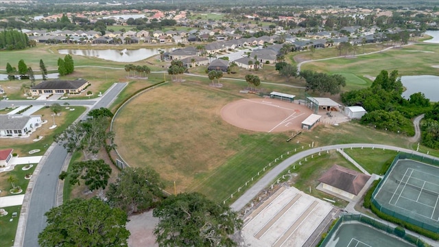 bird's eye view featuring a water view, view of golf course, and a residential view