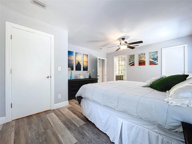 6811 S Himes Ave, Tampa, FL 33611 - bedroom with wood finished floors, baseboards, and ceiling fan