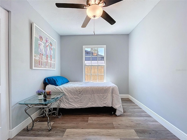 6811 S Himes Ave, Tampa, FL 33611 - bedroom featuring wood finished floors, baseboards, and ceiling fan