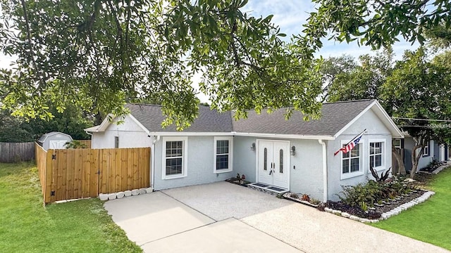 6811 S Himes Ave, Tampa, FL 33611 - view of front of house with stucco siding, a patio area, and roof with shingles