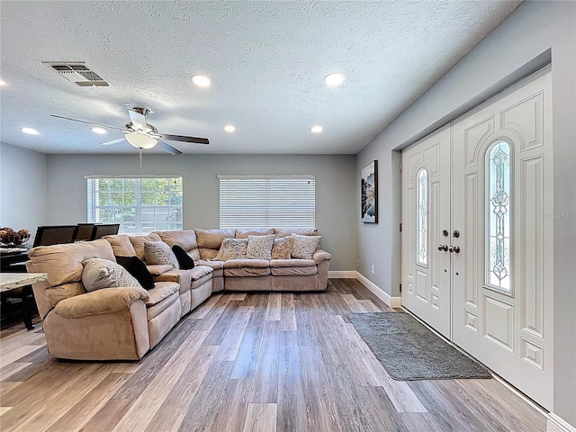 6811 S Himes Ave, Tampa, FL 33611 - living area featuring light wood-type flooring, a textured ceiling, baseboards, ceiling fan, and recessed lighting