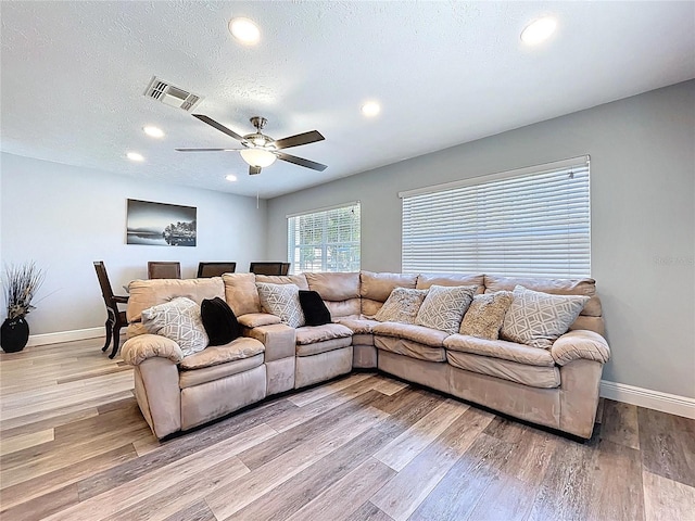 6811 S Himes Ave, Tampa, FL 33611 - living room featuring recessed lighting, baseboards, light wood-type flooring, and a ceiling fan