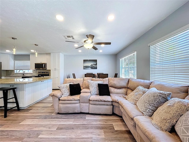 6811 S Himes Ave, Tampa, FL 33611 - living area with light wood-style floors, recessed lighting, and a ceiling fan