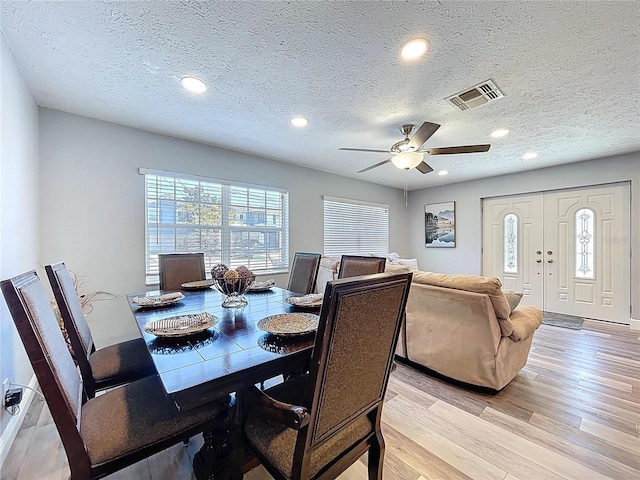 6811 S Himes Ave, Tampa, FL 33611 - dining space featuring light wood-type flooring, a textured ceiling, ceiling fan, and recessed lighting