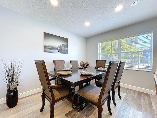 6811 S Himes Ave, Tampa, FL 33611 - dining space with baseboards, light wood-type flooring, a textured ceiling, and recessed lighting