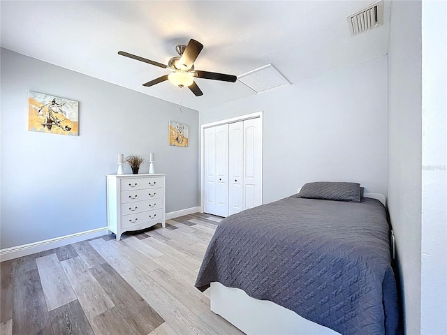 6811 S Himes Ave, Tampa, FL 33611 - bedroom with wood finished floors, ceiling fan, a closet, baseboards, and attic access