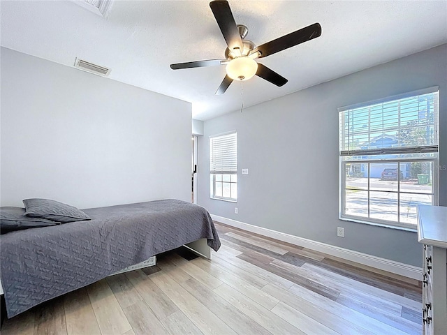 6811 S Himes Ave, Tampa, FL 33611 - bedroom featuring light wood finished floors, baseboards, and ceiling fan