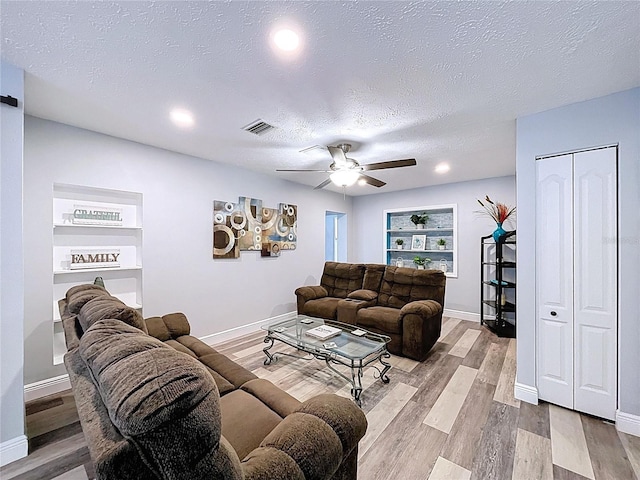 6811 S Himes Ave, Tampa, FL 33611 - living area with ceiling fan, wood finished floors, baseboards, a textured ceiling, and recessed lighting