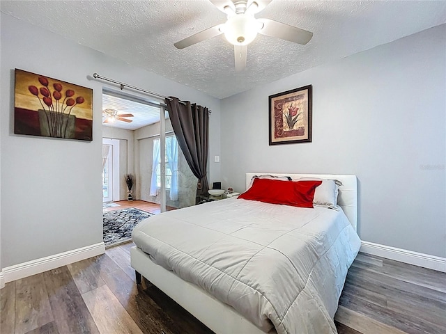 6811 S Himes Ave, Tampa, FL 33611 - bedroom featuring baseboards, wood finished floors, a textured ceiling, and access to outside