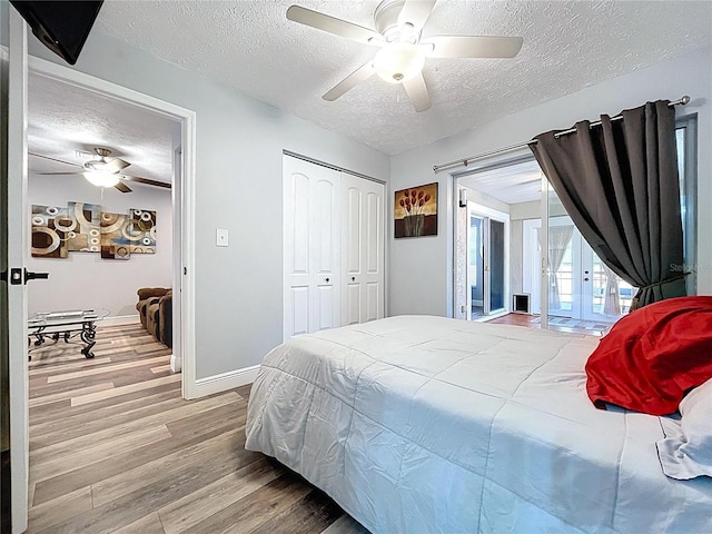 6811 S Himes Ave, Tampa, FL 33611 - bedroom featuring a textured ceiling, wood finished floors, french doors, access to outside, and baseboards