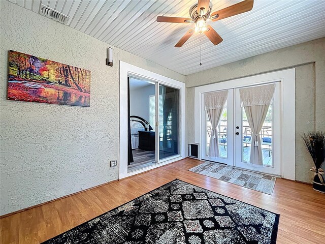 6811 S Himes Ave, Tampa, FL 33611 - doorway to outside featuring a textured wall, wood finished floors, a ceiling fan, and french doors