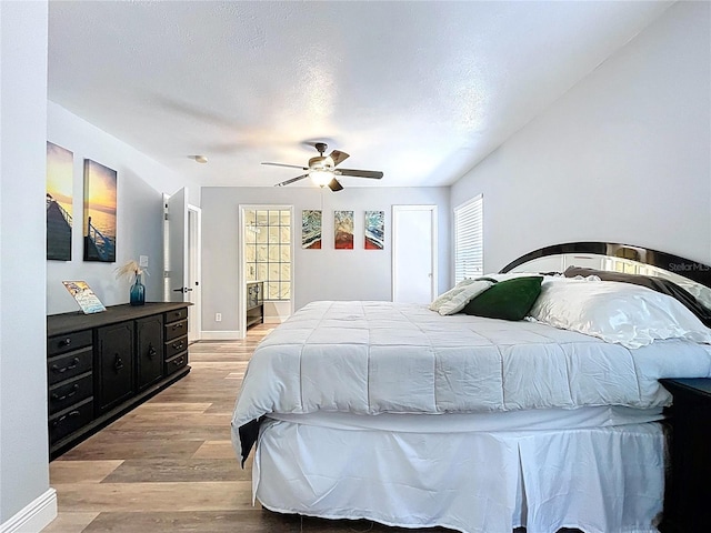 6811 S Himes Ave, Tampa, FL 33611 - bedroom featuring light wood finished floors, multiple windows, ceiling fan, and baseboards
