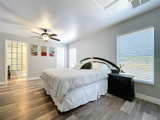6811 S Himes Ave, Tampa, FL 33611 - bedroom featuring baseboards, wood finished floors, ceiling fan, and a textured ceiling