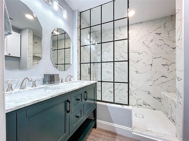 6811 S Himes Ave, Tampa, FL 33611 - full bathroom with wood finished floors, double vanity, a shower, and baseboards
