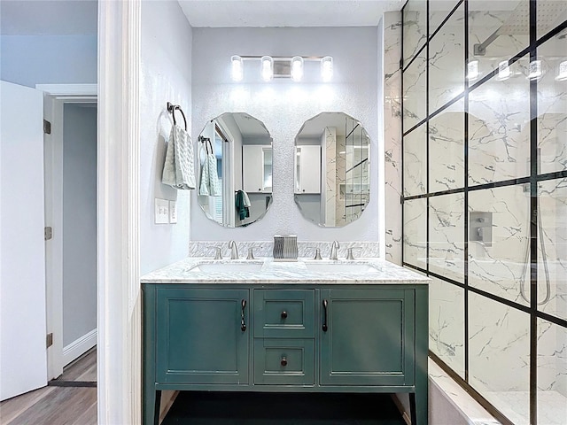 6811 S Himes Ave, Tampa, FL 33611 - bathroom featuring double vanity, a marble finish shower, and wood finished floors