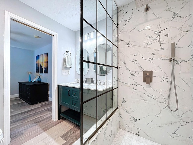6811 S Himes Ave, Tampa, FL 33611 - full bathroom featuring double vanity, a marble finish shower, and wood finished floors