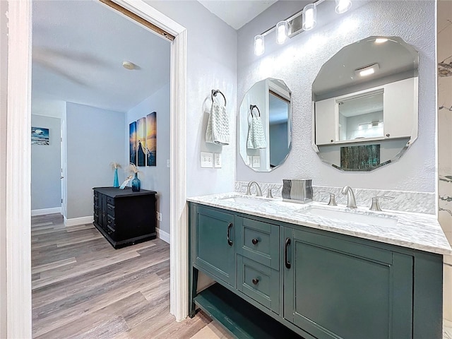 6811 S Himes Ave, Tampa, FL 33611 - full bathroom featuring wood finished floors, double vanity, and baseboards