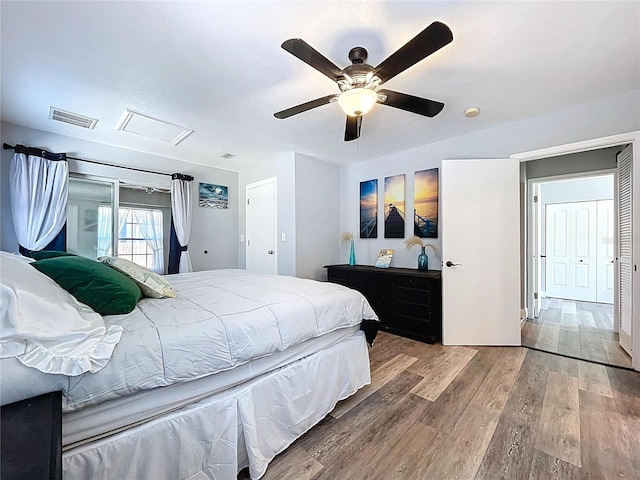 6811 S Himes Ave, Tampa, FL 33611 - bedroom with attic access, wood finished floors, and a ceiling fan