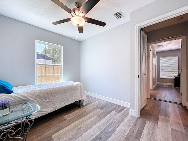 6811 S Himes Ave, Tampa, FL 33611 - bedroom with wood finished floors, baseboards, and ceiling fan