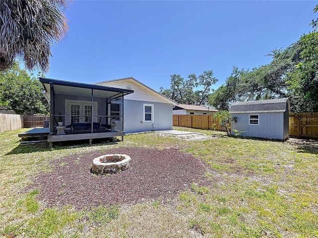 6811 S Himes Ave, Tampa, FL 33611 - rear view of house with an outdoor fire pit, a wooden deck, and french doors
