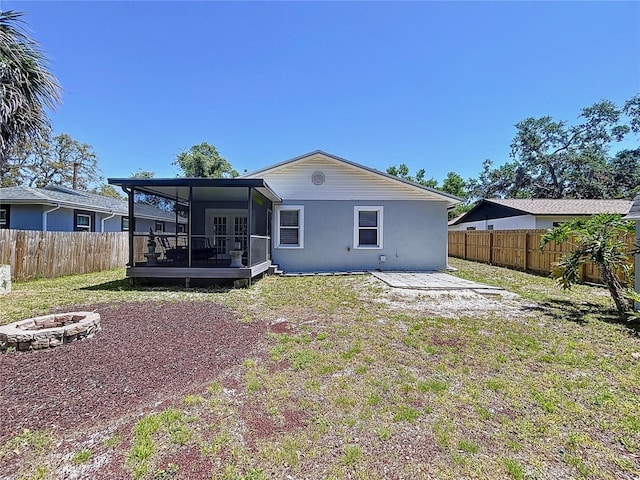 6811 S Himes Ave, Tampa, FL 33611 - rear view of property featuring a fire pit, a sunroom, a deck, and french doors