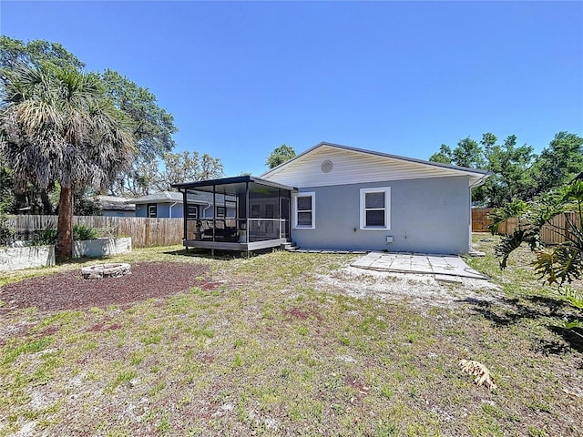 6811 S Himes Ave, Tampa, FL 33611 - rear view of house featuring a sunroom and stucco siding