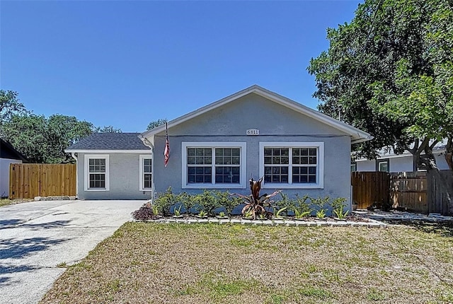 6811 S Himes Ave, Tampa, FL 33611 - view of front of house with stucco siding and driveway