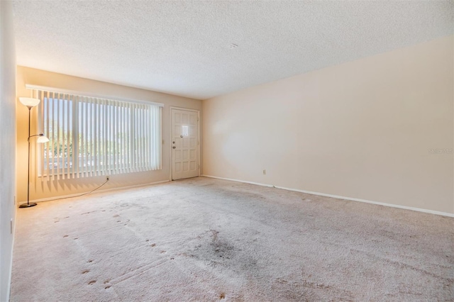2310 Denmark St Unit 30, Clearwater, FL 33763 - carpeted spare room featuring a textured ceiling and baseboards