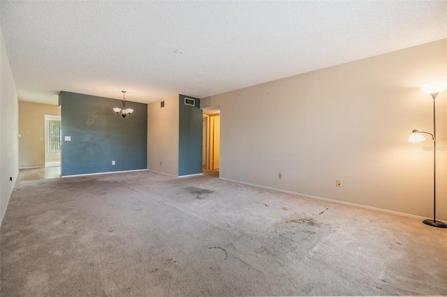 2310 Denmark St Unit 30, Clearwater, FL 33763 - carpeted empty room with a chandelier, baseboards, and a textured ceiling