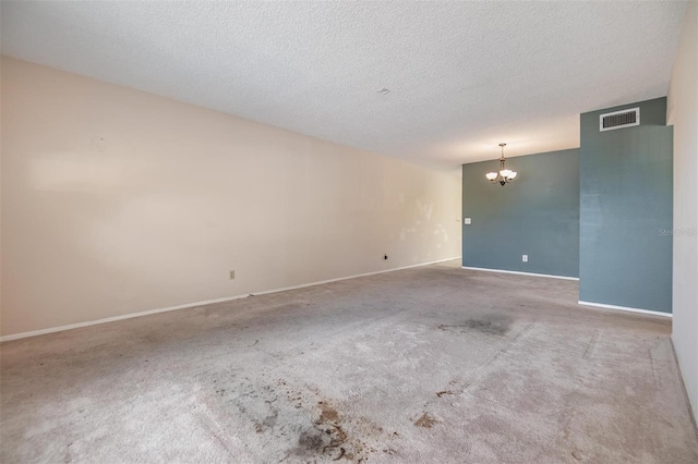 2310 Denmark St Unit 30, Clearwater, FL 33763 - carpeted spare room featuring a chandelier, baseboards, and a textured ceiling