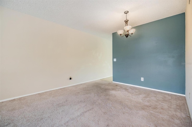 2310 Denmark St Unit 30, Clearwater, FL 33763 - carpeted empty room featuring a chandelier, baseboards, and a textured ceiling