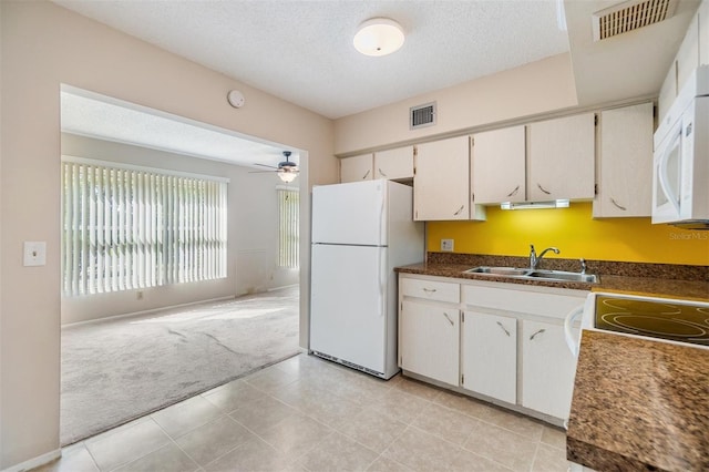 2310 Denmark St Unit 30, Clearwater, FL 33763 - kitchen with white appliances, a sink, light colored carpet, a textured ceiling, and a ceiling fan
