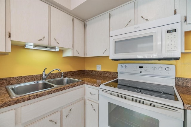 2310 Denmark St Unit 30, Clearwater, FL 33763 - kitchen featuring white appliances, a sink, and dark countertops