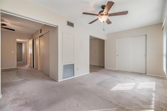 2310 Denmark St Unit 30, Clearwater, FL 33763 - unfurnished bedroom with two closets, carpet floors, and ceiling fan