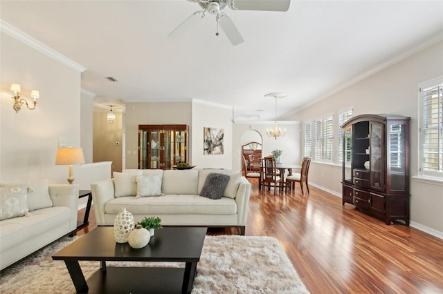 15324 Sherwood Forest Dr, Tampa, FL 33647 - living area featuring a chandelier, ornamental molding, wood finished floors, baseboards, and a ceiling fan