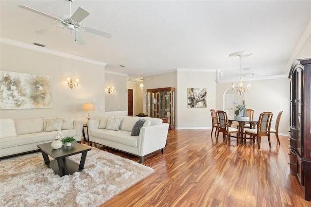 15324 Sherwood Forest Dr, Tampa, FL 33647 - living area with ornamental molding, wood finished floors, a chandelier, baseboards, and a ceiling fan