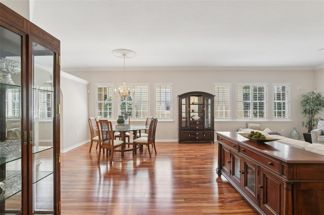 15324 Sherwood Forest Dr, Tampa, FL 33647 - dining space with dark wood finished floors, crown molding, a chandelier, and baseboards